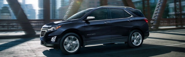 2021 Chevrolet Equinox driving over a city bridge