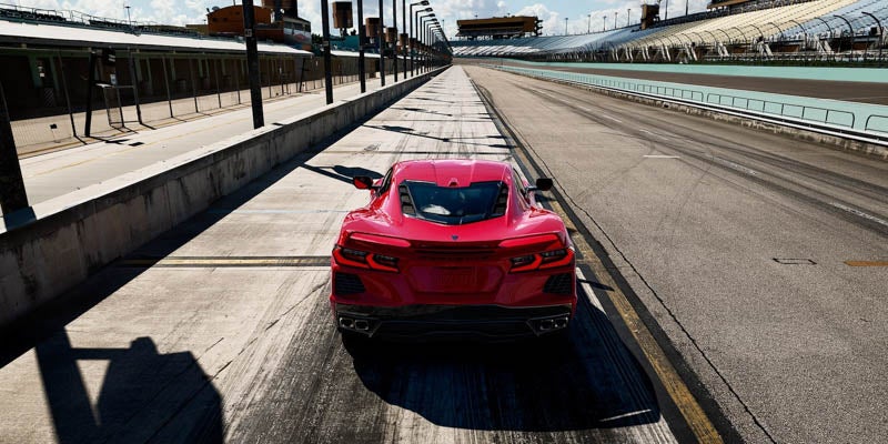 Aerial view of the back of a 2022 Chevrolet Corvette driving on the road