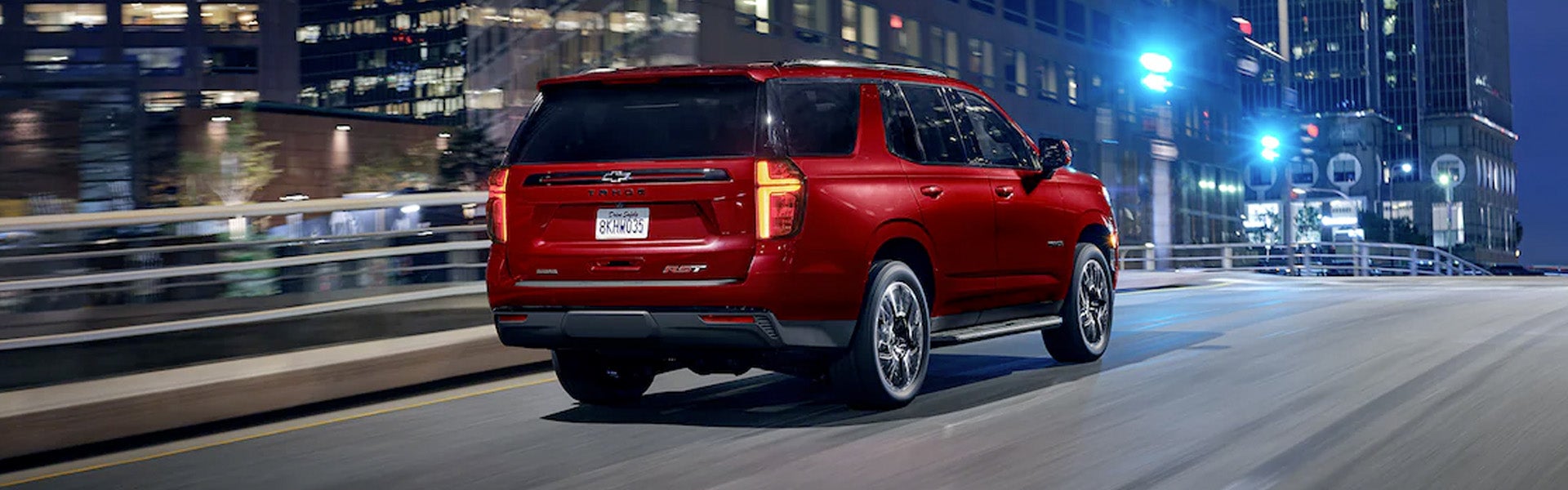 Rear view of a 2022 Chevrolet Tahoe driving on the road