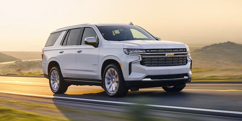 Front view of a 2022 Chevrolet Tahoe driving on the road