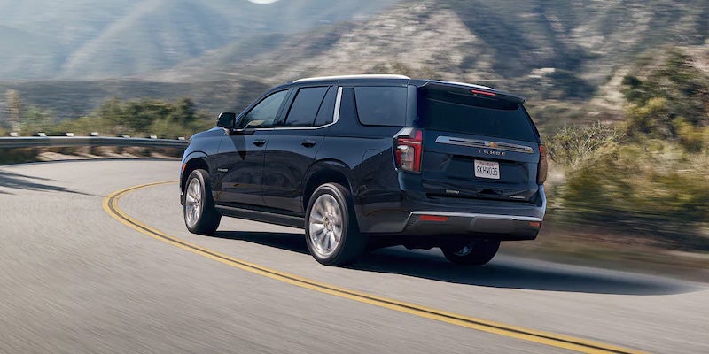 Rear view of a 2022 Chevrolet Tahoe driving on the road