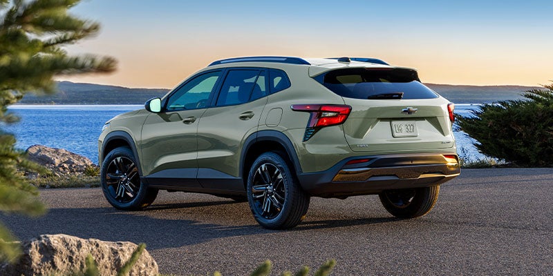 Rear view of a 2024 Chevrolet Trax parked by a body of water