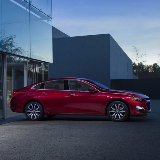 Chevrolet Malibu parked in fron of a dealership